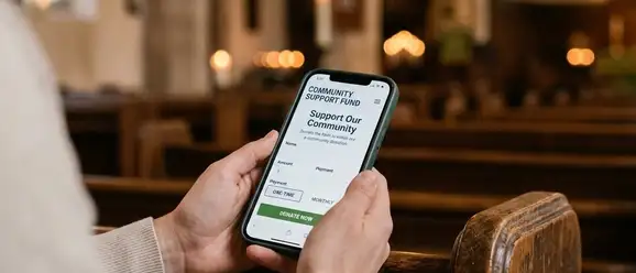 Church leader planning a digital giving strategy on a tablet with giving analytics on screen